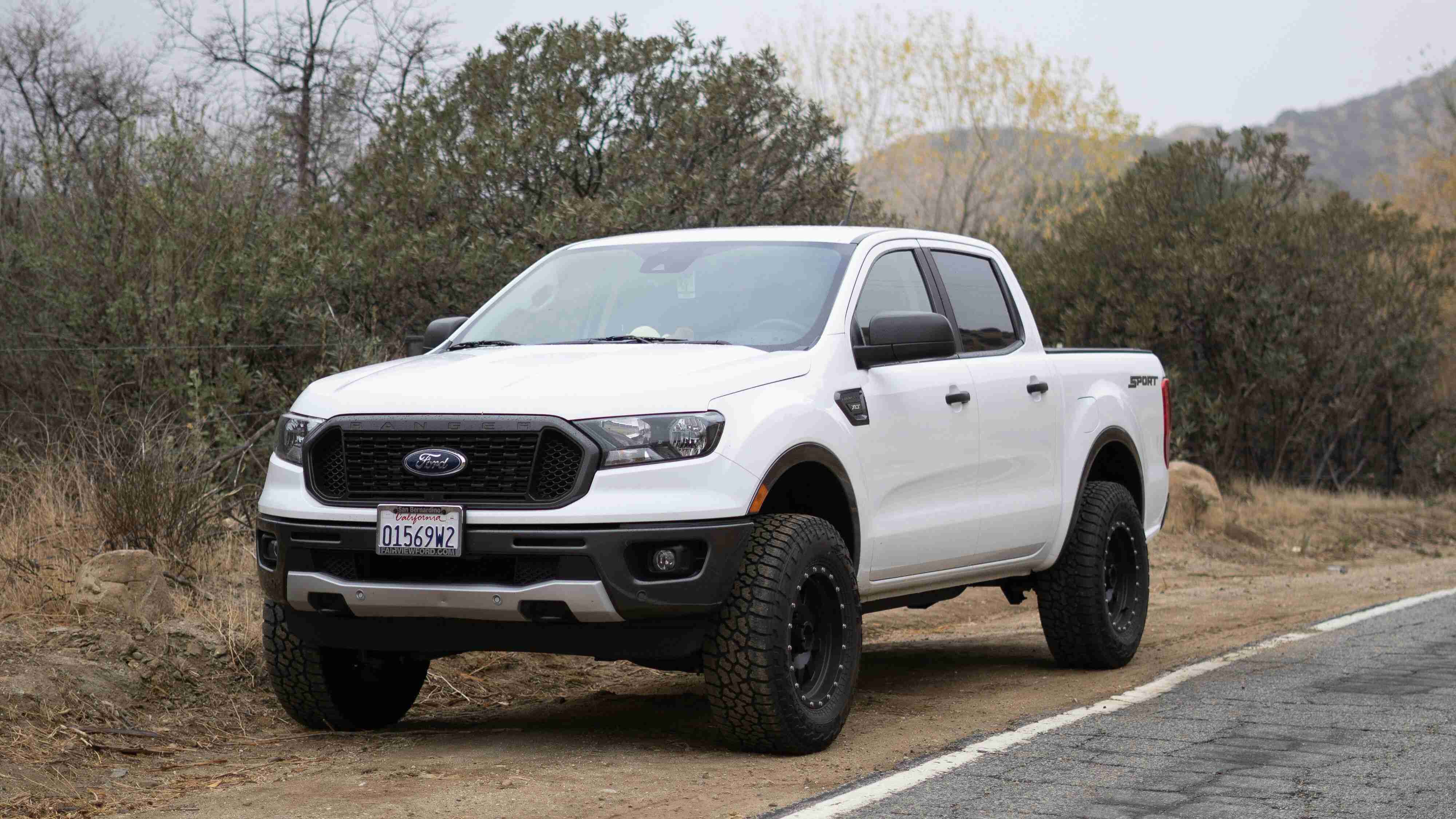 White Pickup Truck Parked on Side of the Road