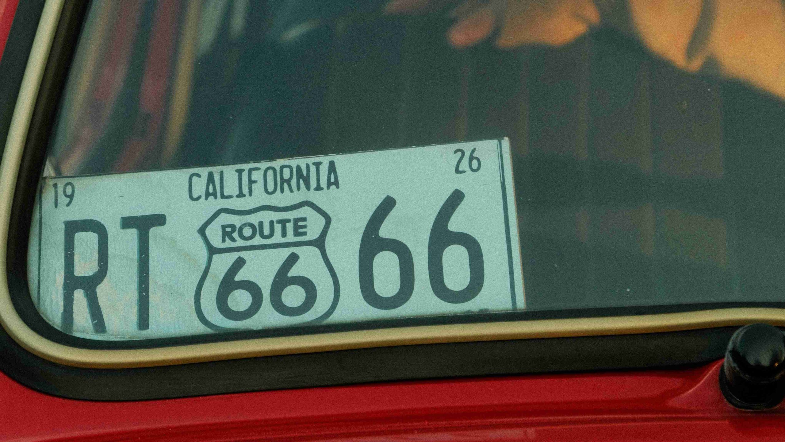 A Black and White License Plate in a Red Car